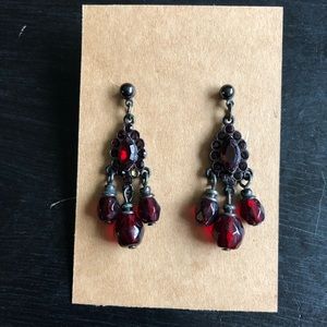 Red dangly earrings in a black setting